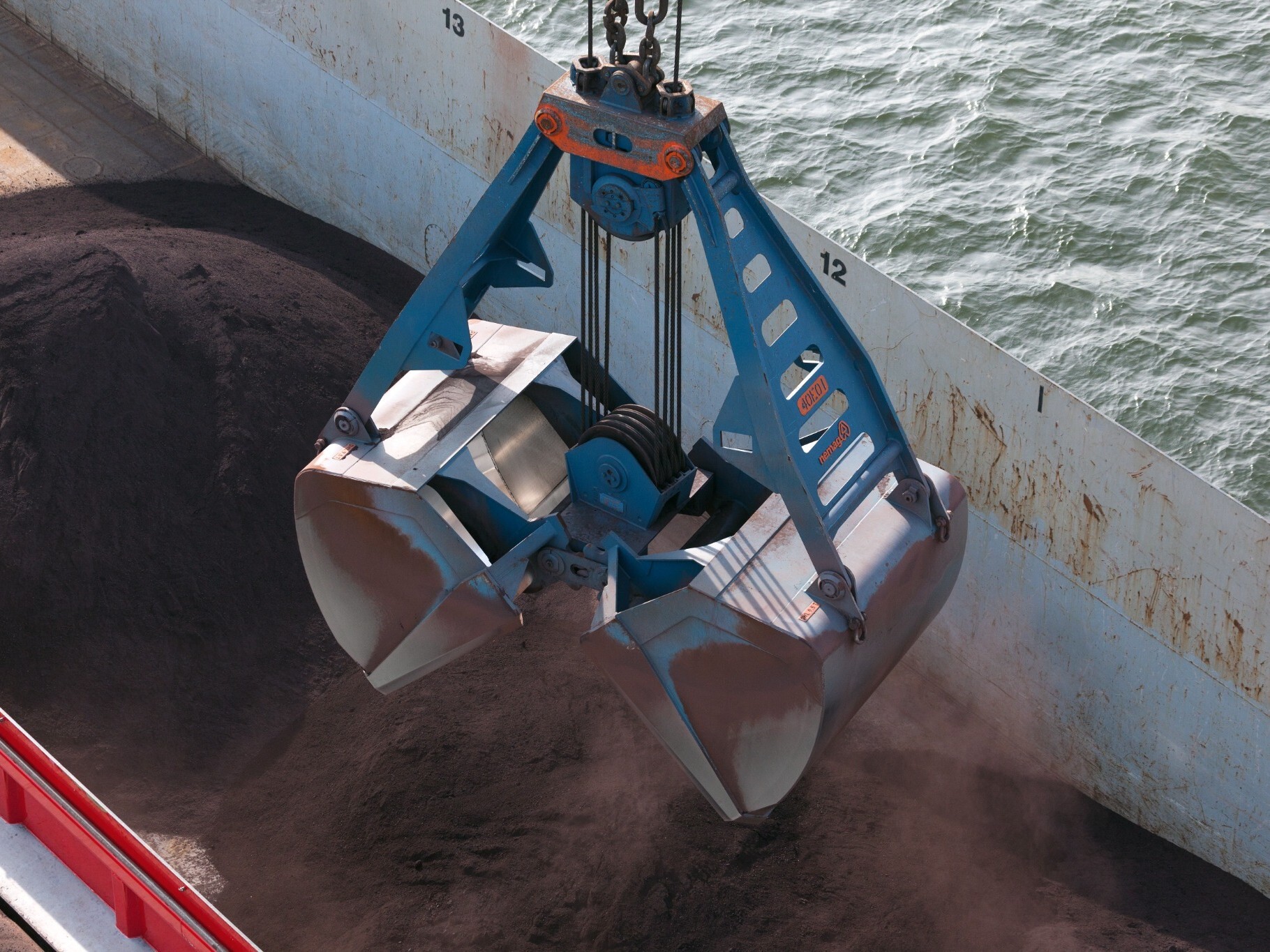 Blue clamshell grab in Iron Ore